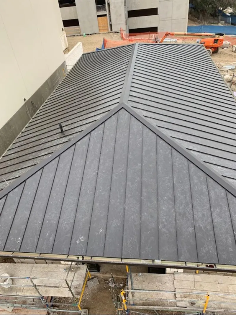 Commercial metal roof construction with crane equipment in Lynden